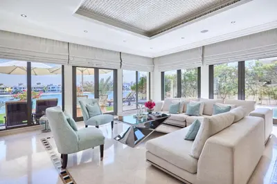 a living room with a couch and a table and chairs at JuliusHomes-Villa Noor in Dubai