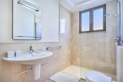 a bathroom with a sink and a shower at JuliusHomes-Villa Noor in Dubai