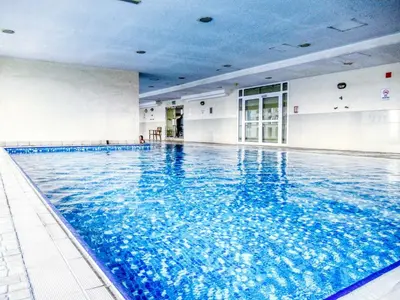 a large swimming pool with blue water in a building at Elegant 1BR with Balcony in Dubai Marina by EE Holiday Homes in Dubai