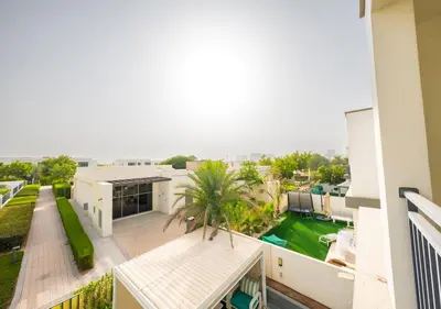 an apartment balcony with a view of a yard at Luxury Maple 3 Villa in Dubai Hills with Private Garden in Dubai