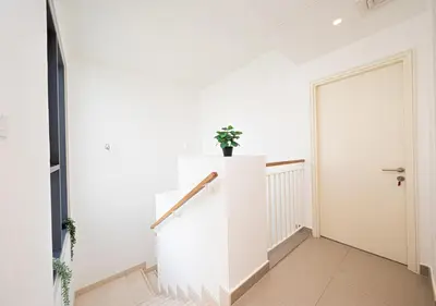 a white hallway with a staircase and a door at Luxury Maple 3 Villa in Dubai Hills with Private Garden in Dubai