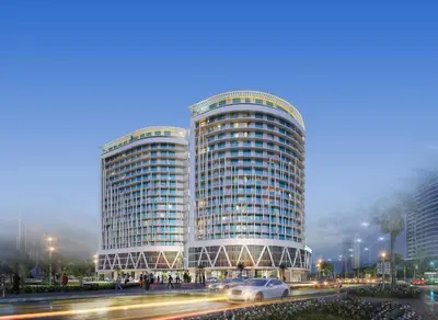 two tall buildings with cars in front of a street at Silk Valley - Luxury DAMAC Studio near Dubai Mall & Burj Khalifa in Dubai