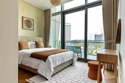 a bedroom with a bed and a large window at Private Room in Luxurious 3BR Apt in Downtown, Direct Access to Dubai Mall and Metro in Dubai