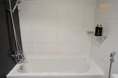 a white bath tub in a bathroom with a shower at Wake Up to the Burj Khalifa Stunning view 1BR Stay in Dubai