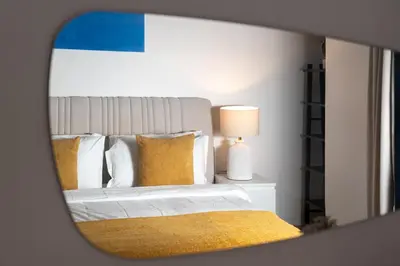 a reflection of a bed in a mirror at Luxe 3 Bedroom Apartment with Maid Room, Dubai Eye and Sea View in Dubai