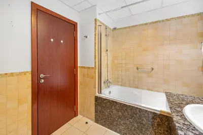 a bathroom with a tub and a sink at Luxe 3 Bedroom Apartment with Maid Room, Dubai Eye and Sea View in Dubai