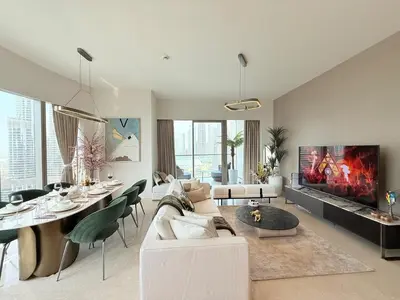 a living room with a couch and a table and a fireplace at UNIQUE - BURJ KHALIFA & FOUNTAIN ViEW-4 BR in Dubai