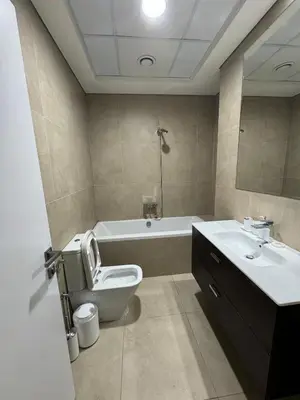 a bathroom with a toilet and a sink and a tub at Joyful Journeys Marina Arcade Private Room for 2 - Shared Kitchen in Dubai