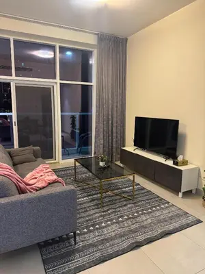 a living room with a couch and a flat screen tv at Joyful Journeys Marina Arcade Private Room for 2 - Shared Kitchen in Dubai