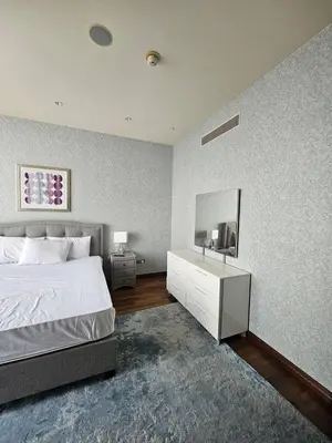 a bedroom with a bed and a tv on a wall at Apartment in the heart of Dubai - in Burj Khalifa in Dubai