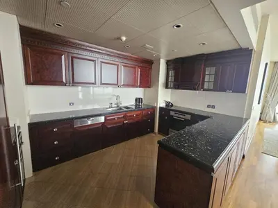 a kitchen with wooden cabinets and a black counter top at Apartment in the heart of Dubai - in Burj Khalifa in Dubai