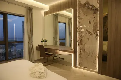 a bedroom with a desk and a table with a mirror at The Royale Vista Burj Khalifa View Residence in Dubai