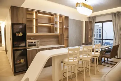 a kitchen and dining room with a table and chairs at The Royale Vista Burj Khalifa View Residence in Dubai