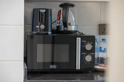 a coffee maker is sitting on top of a microwave at Luxury JLT Studio Lakeview Near Metro & Marina in Dubai