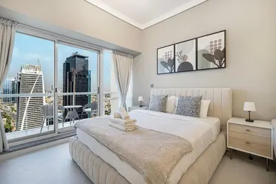 a bedroom with a large bed and a large window at Luxury JLT Studio Lakeview Near Metro & Marina in Dubai