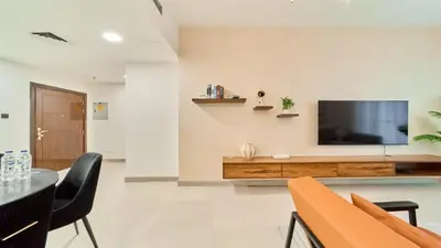 a living room with a television on a wall at fam Living High Floor Stay in Sulafa Tower in Dubai
