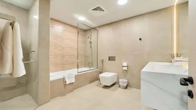 a bathroom with a sink and a toilet and a tub at fam Living High Floor Stay in Sulafa Tower in Dubai