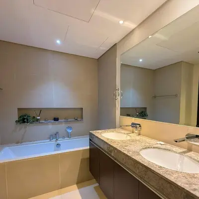 a bathroom with two sinks and a bath tub at Spacious Luxury Apartment Stunning Creek Views Family Friendly in Dubai