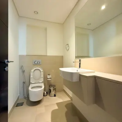 a bathroom with a toilet and a sink at Spacious Luxury Apartment Stunning Creek Views Family Friendly in Dubai