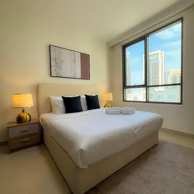 a bedroom with a large bed with a large window at Spacious Luxury Apartment Stunning Creek Views Family Friendly in Dubai