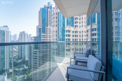 a balcony with two chairs and a view of a city at Burj Khalifa - Fountain View - Astonishing Home in Dubai