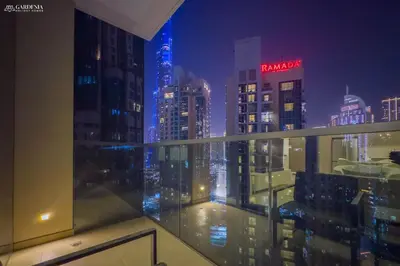 a view of a city skyline at night at Burj Khalifa - Fountain View - Astonishing Home in Dubai