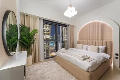 a bedroom with a large bed and a large window at Modern stylish 2BR Apartment walk to Dubai Mall near Burj Khalifa in Dubai