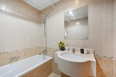 a bathroom with a sink and a tub and a mirror at Vibrant 1 Bedroom Marina View - Stylish and Bright Stay in Dubai