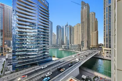 a bridge over a river in a city with cars at Vibrant 1 Bedroom Marina View - Stylish and Bright Stay in Dubai