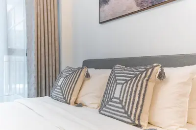 a bed with two pillows on top of it at Modern studio - Burj & canal view in Dubai