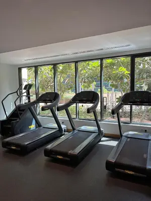 a group of three treadmills in a gym with a window at Modern studio - Burj & canal view in Dubai