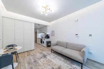 a living room with a couch and a table at Modern studio - Burj & canal view in Dubai