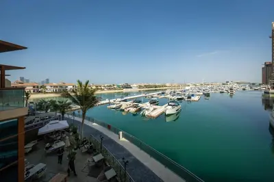a group of boats docked in a marina at Palm Jumeirah Lifestyle - Elegant Waterfront Studio in Dubai