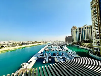 a view of a marina with boats in the water at Palm Jumeirah Lifestyle - Elegant Waterfront Studio in Dubai