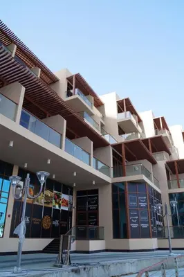 a building with a restaurant with signs on it at Palm Jumeirah Lifestyle - Elegant Waterfront Studio in Dubai