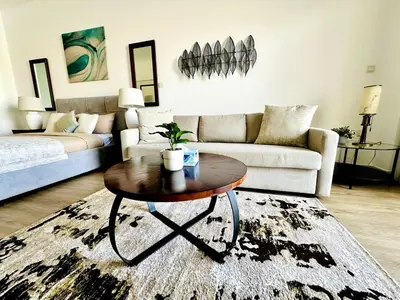 a living room with a coffee table and a couch at Palm Jumeirah Lifestyle - Elegant Waterfront Studio in Dubai