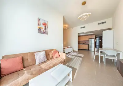 a living room with a couch and a table at Luxurious apartment with Burj Khalifa & Canal Views in Dubai