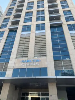 a large building with the name of a hospital at Luxurious apartment with Burj Khalifa & Canal Views in Dubai