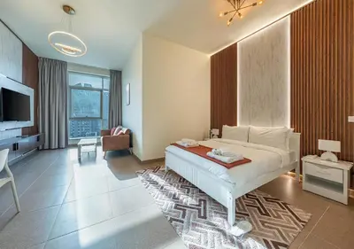 a bedroom with a bed and a living room at Luxurious apartment with Burj Khalifa & Canal Views in Dubai