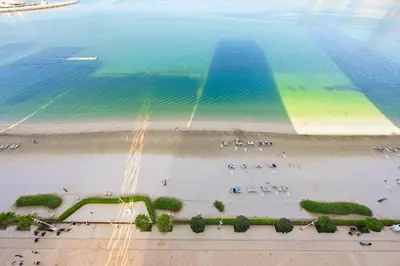 an aerial view of a beach and the ocean at Luxury 2BR Emaar Beachfront with Private Beach & Infinity Pool, Palm Jumeirah & Atlantis Views in Dubai