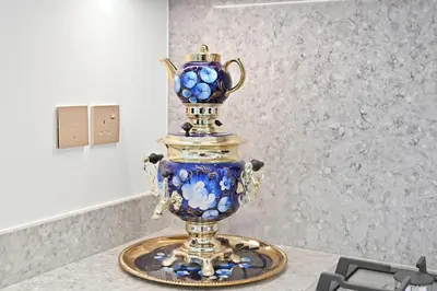 a blue and gold vase on a table at Luxury 2BR Emaar Beachfront with Private Beach & Infinity Pool, Palm Jumeirah & Atlantis Views in Dubai