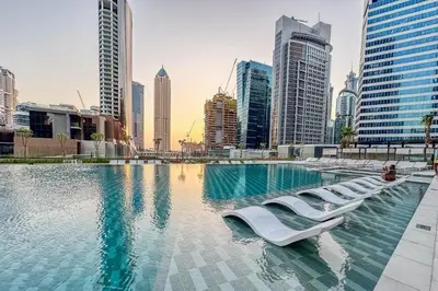 a swimming pool in a city with tall buildings at Artistic 2Bedroom with Skyline Khalifa View in Dubai