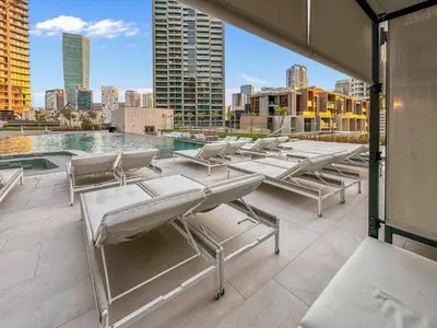 a patio with lounge chairs and a pool on a building at Artistic 2Bedroom with Skyline Khalifa View in Dubai