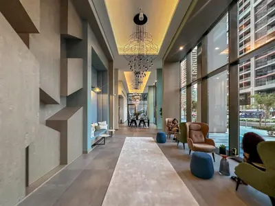 an office lobby with a hallway with chairs and windows at Artistic 2Bedroom with Skyline Khalifa View in Dubai
