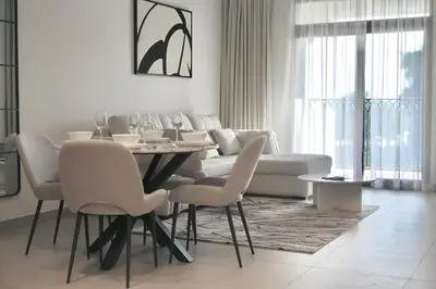 a living room with a table and a couch at 1BR Madinat Jumeirah Living in Dubai