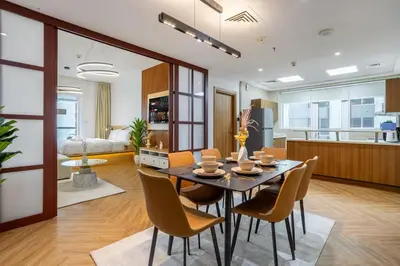 a dining room and living room with a table and chairs at Luxury Condo 3 BR in Dubai Marina Sulafa 4004 in Dubai