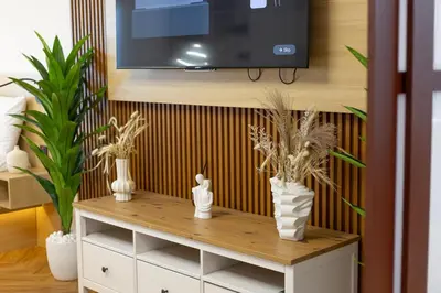 a living room with a tv and a table with plants at Luxury Condo 3 BR in Dubai Marina Sulafa 4004 in Dubai