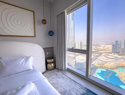 a bedroom with a bed and a large window at GRANDE SIGNATURE with a direct Burj Khalifa view and Private Fountain Show at 62nd floor with DXB AIRPORT VIP Shuttle option for 6 guests in Dubai