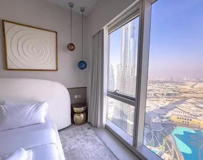 a bedroom with a bed and a large window at GRANDE SIGNATURE with a direct Burj Khalifa view and Private Fountain Show at 62nd floor with DXB AIRPORT VIP Shuttle option for 6 guests in Dubai