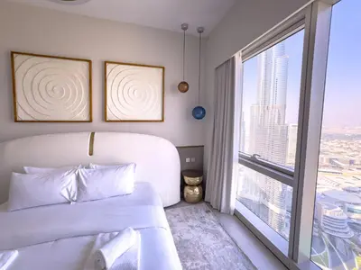 a bedroom with a bed and a large window at GRANDE SIGNATURE with a direct Burj Khalifa view and Private Fountain Show at 62nd floor with DXB AIRPORT VIP Shuttle option for 6 guests in Dubai